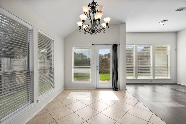 11047 Pierce Valley Dr, Richmond, TX 77406 - doorway to outside featuring healthy amount of natural light, tile patterned flooring, a chandelier, and lofted ceiling