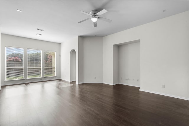 11047 Pierce Valley Dr, Richmond, TX 77406 - unfurnished room with arched walkways, ceiling fan, and dark wood finished floors