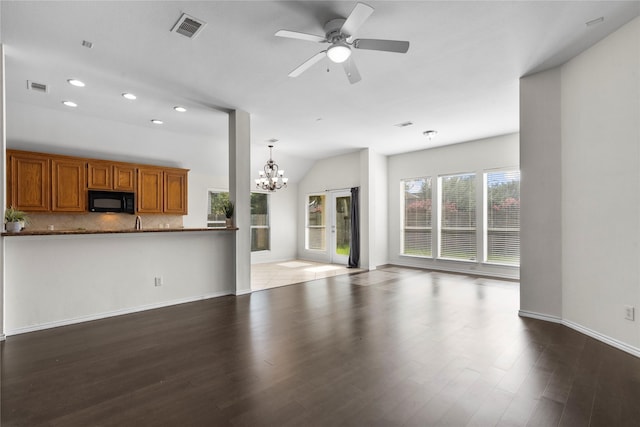 11047 Pierce Valley Dr, Richmond, TX 77406 - unfurnished living room with a chandelier, dark wood-style flooring, recessed lighting, ceiling fan, and vaulted ceiling