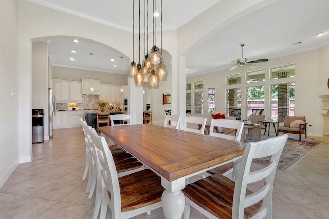 18774 Monetta Dr, New Caney, TX 77357 - dining area with arched walkways, a ceiling fan, crown molding, and recessed lighting