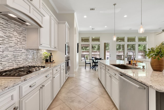 18774 Monetta Dr, New Caney, TX 77357 - kitchen featuring appliances with stainless steel finishes, range hood, ornamental molding, white cabinetry, and backsplash