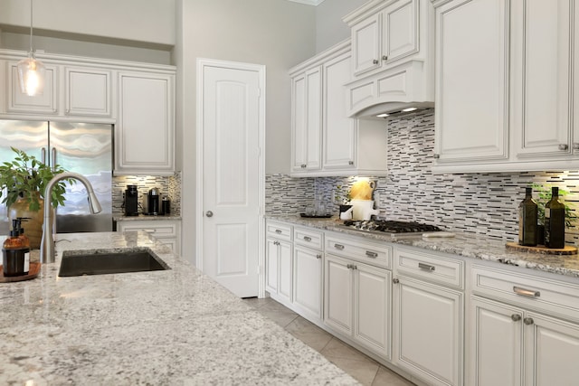 18774 Monetta Dr, New Caney, TX 77357 - kitchen with appliances with stainless steel finishes, backsplash, and white cabinetry
