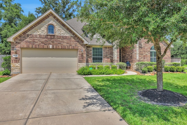 18774 Monetta Dr, New Caney, TX 77357 - view of front of house with a front yard, brick siding, driveway, an attached garage, and roof with shingles