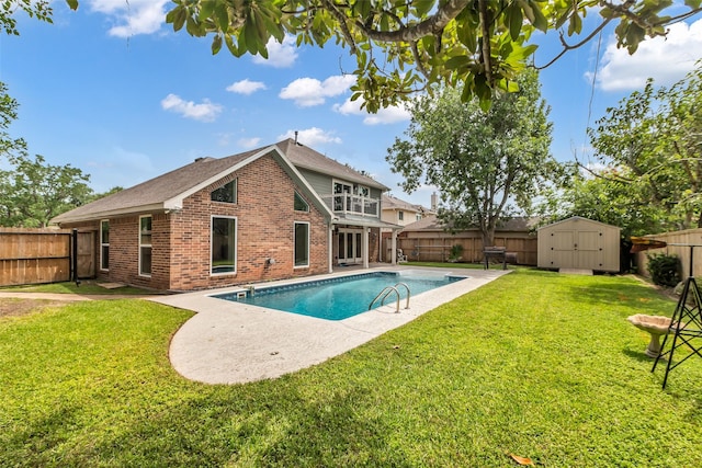 2504 Leroy St, Pearland, TX 77581 - back of property featuring brick siding, a fenced backyard, a storage shed, a patio area, and a balcony