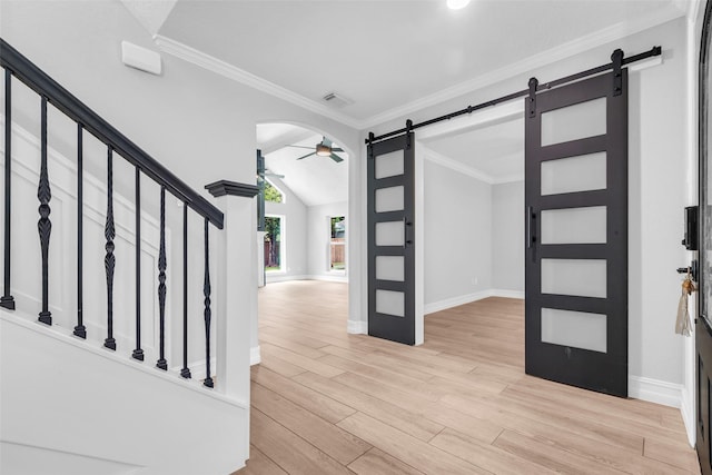 2504 Leroy St, Pearland, TX 77581 - foyer with a barn door, a ceiling fan, light wood-type flooring, ornamental molding, and stairway
