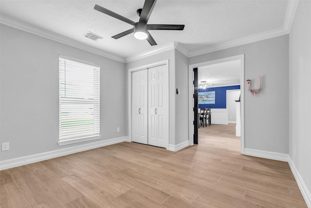 2504 Leroy St, Pearland, TX 77581 - unfurnished bedroom featuring a textured ceiling, light wood-style flooring, ornamental molding, a closet, and ceiling fan