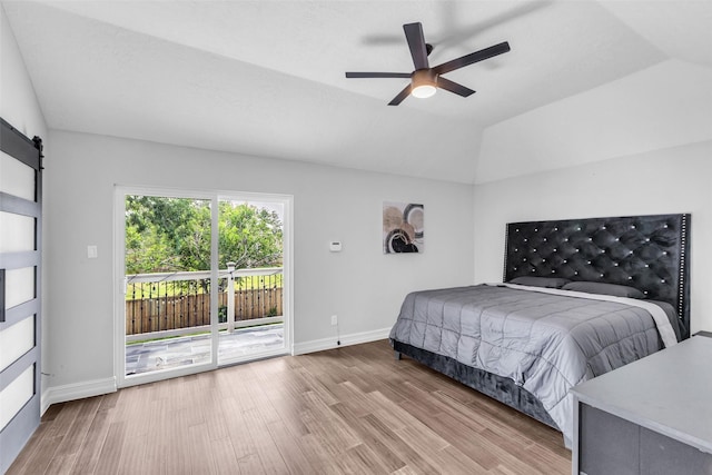 2504 Leroy St, Pearland, TX 77581 - bedroom featuring access to exterior, wood finished floors, a barn door, lofted ceiling, and ceiling fan