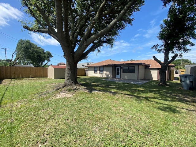 2512 Pine St, Galveston, TX 77551 - fenced backyard featuring a storage shed