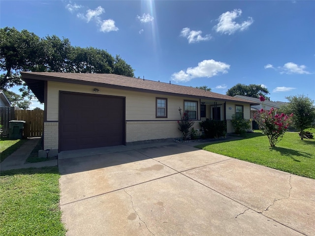 2512 Pine St, Galveston, TX 77551 - ranch-style house with brick siding, an attached garage, and driveway