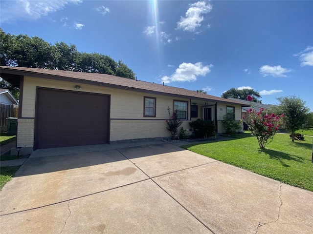 2512 Pine St, Galveston, TX 77551 - single story home featuring brick siding, a garage, concrete driveway, and a front yard