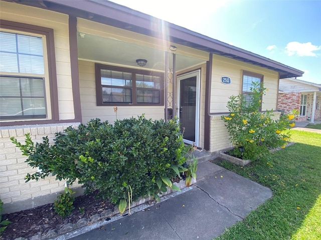 2512 Pine St, Galveston, TX 77551 - property entrance featuring brick siding and a porch