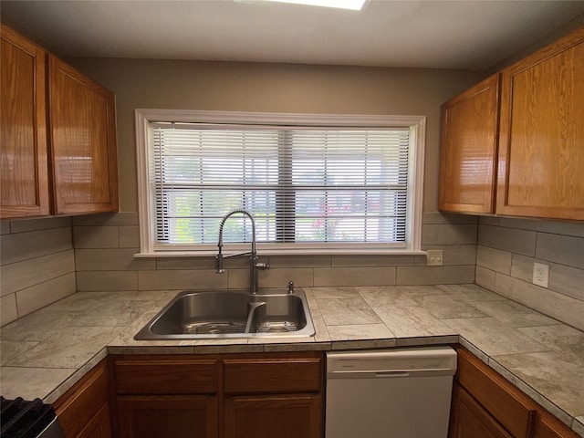 2512 Pine St, Galveston, TX 77551 - kitchen featuring white dishwasher, tasteful backsplash, brown cabinets, and tile countertops
