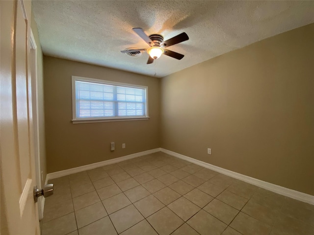 2512 Pine St, Galveston, TX 77551 - empty room featuring a ceiling fan, light tile patterned flooring, and a textured ceiling
