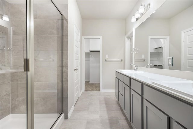 828 Laguna Green Ln, Katy, TX 77493 - bathroom with a walk in closet, double vanity, and a shower stall