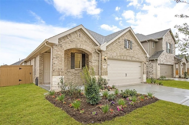 828 Laguna Green Ln, Katy, TX 77493 - view of front of home with brick siding, concrete driveway, a garage, a front lawn, and stone siding
