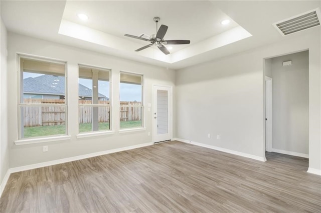 828 Laguna Green Ln, Katy, TX 77493 - spare room with a raised ceiling, wood finished floors, a ceiling fan, and recessed lighting