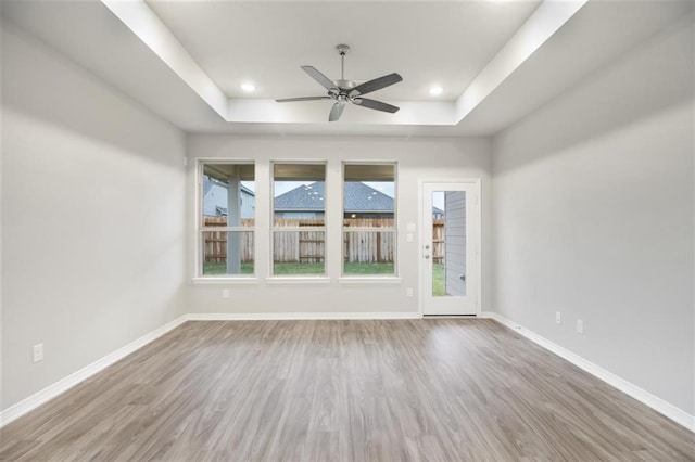 828 Laguna Green Ln, Katy, TX 77493 - spare room featuring a tray ceiling, ceiling fan, and wood finished floors