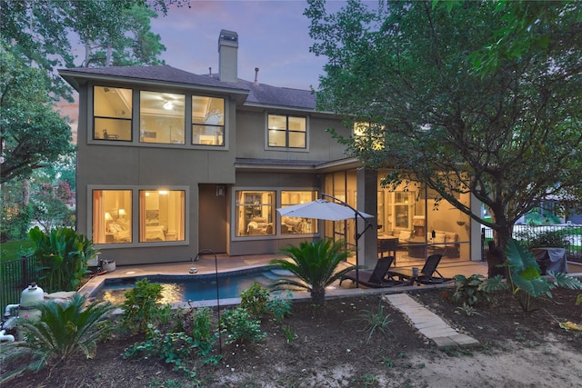 3 Creekwood Dr, Montgomery, TX 77356 - rear view of house with stucco siding, a patio, a chimney, and a shingled roof