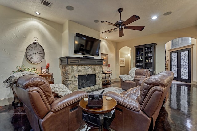 3 Creekwood Dr, Montgomery, TX 77356 - living area with arched walkways, a ceiling fan, a fireplace, recessed lighting, and a textured ceiling