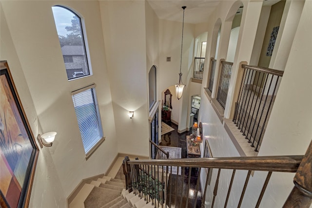 3 Creekwood Dr, Montgomery, TX 77356 - staircase featuring a high ceiling and arched walkways