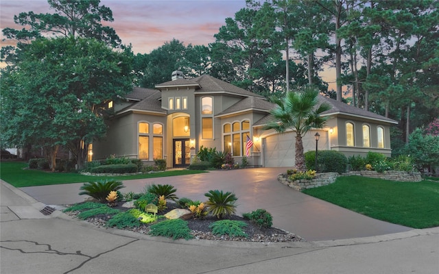 3 Creekwood Dr, Montgomery, TX 77356 - mediterranean / spanish home with stucco siding, curved driveway, an attached garage, a front lawn, and a shingled roof