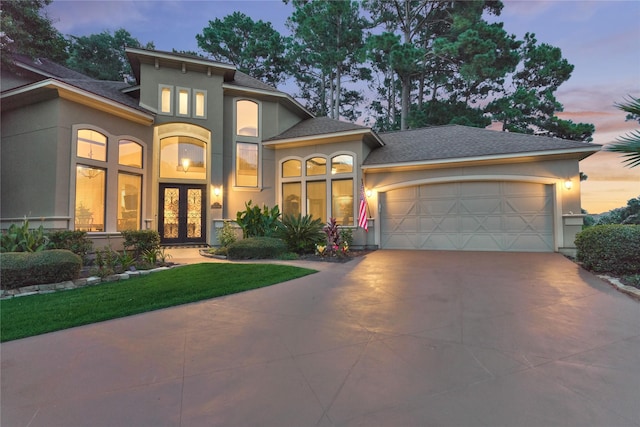 3 Creekwood Dr, Montgomery, TX 77356 - mediterranean / spanish-style house with french doors, stucco siding, a garage, driveway, and roof with shingles