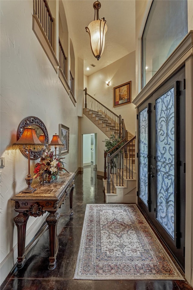 3 Creekwood Dr, Montgomery, TX 77356 - foyer entrance featuring stairway, finished concrete flooring, and a high ceiling