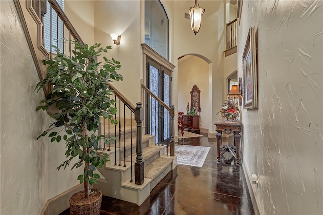 3 Creekwood Dr, Montgomery, TX 77356 - entryway with arched walkways, finished concrete flooring, stairs, and a high ceiling