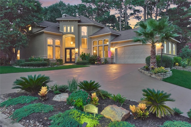 3 Creekwood Dr, Montgomery, TX 77356 - mediterranean / spanish-style house with french doors, stucco siding, a garage, concrete driveway, and a shingled roof