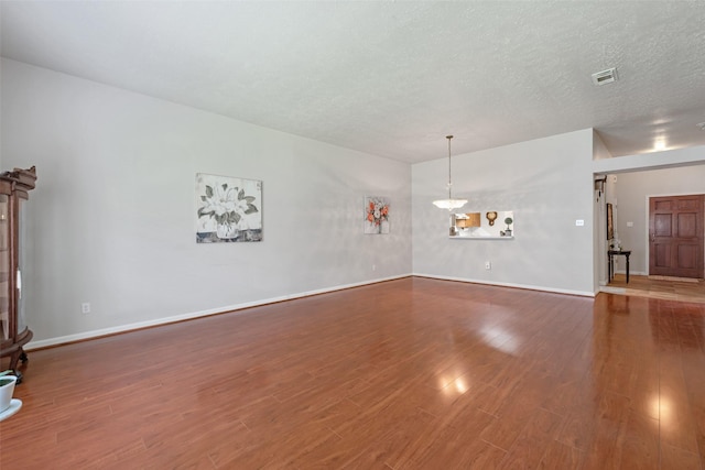 3310 Country Meadows Ct, Pearland, TX 77584 - unfurnished living room featuring wood finished floors and a textured ceiling
