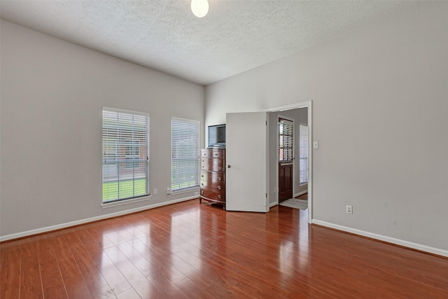 3310 Country Meadows Ct, Pearland, TX 77584 - spare room featuring wood finished floors, healthy amount of natural light, and a textured ceiling