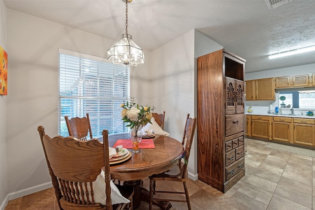 3310 Country Meadows Ct, Pearland, TX 77584 - dining space with a chandelier and a textured ceiling