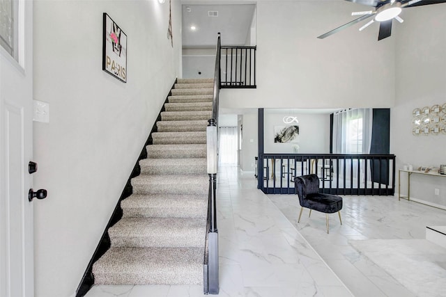 12102 Benmore Dr, Houston, TX 77099 - stairway with marble finish floors, a high ceiling, and ceiling fan