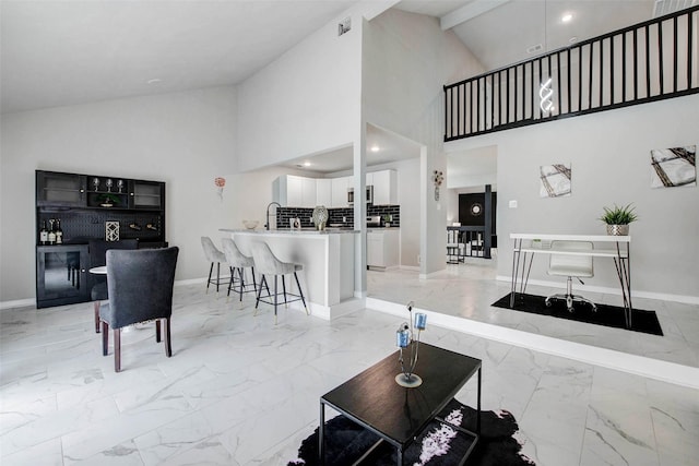 12102 Benmore Dr, Houston, TX 77099 - living room featuring light marble finish floors and high vaulted ceiling