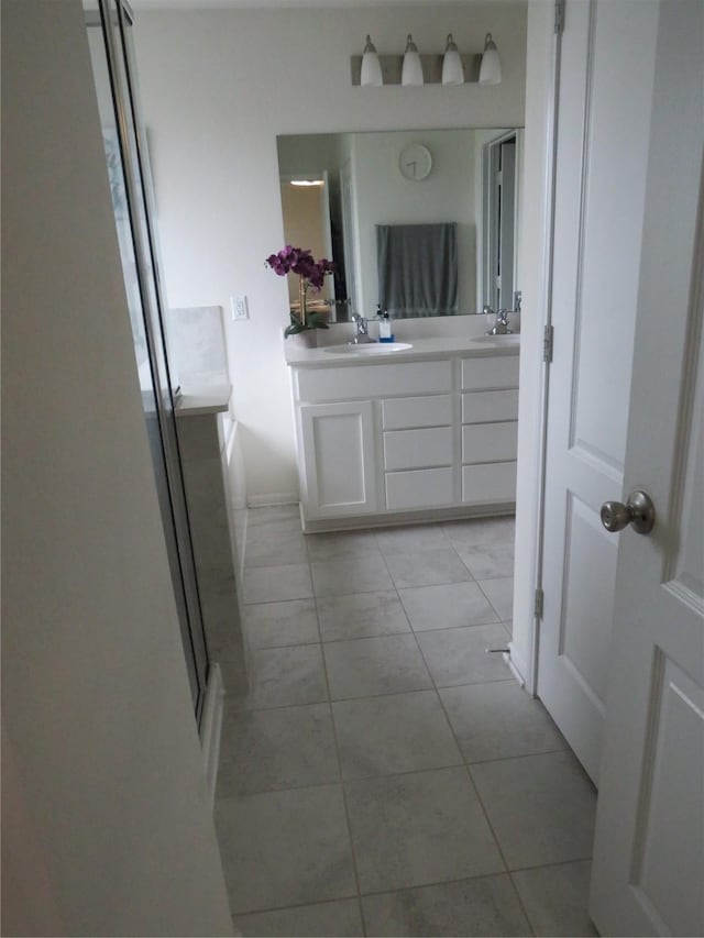 5218 Stone Castle Tower St, Katy, TX 77493 - full bath featuring double vanity, tile patterned floors, and a shower with shower door