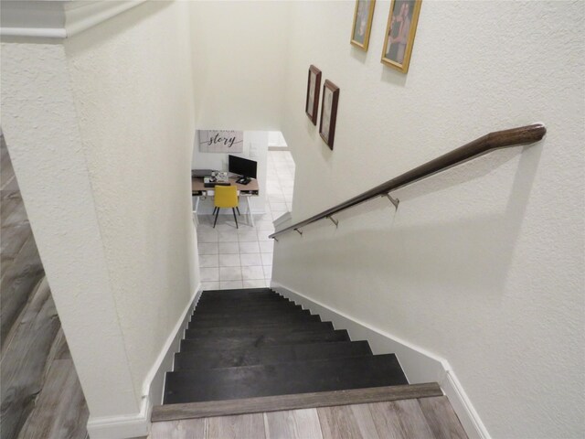 5218 Stone Castle Tower St, Katy, TX 77493 - staircase with a textured wall and wood finished floors