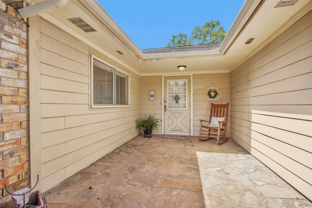 4818 Lost Lake Ln, Spring, TX 77388 - view of exterior entry featuring a patio area and a shingled roof
