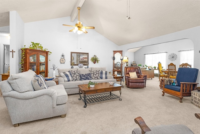 4818 Lost Lake Ln, Spring, TX 77388 - living room featuring arched walkways, light carpet, beamed ceiling, high vaulted ceiling, and a ceiling fan