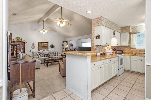 4818 Lost Lake Ln, Spring, TX 77388 - kitchen featuring white electric stove, a textured ceiling, ceiling fan, a peninsula, and white cabinets