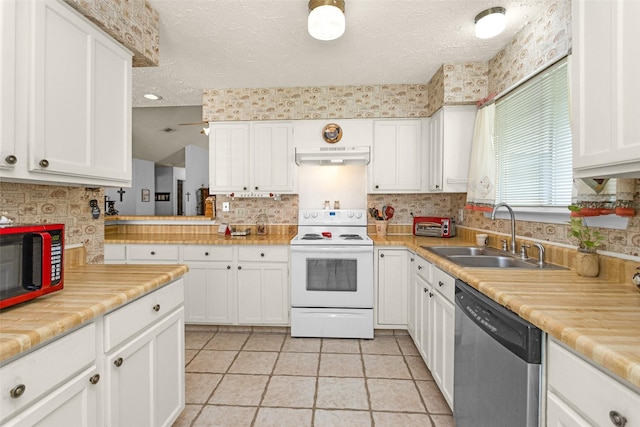 4818 Lost Lake Ln, Spring, TX 77388 - kitchen with white electric range oven, stainless steel dishwasher, under cabinet range hood, white cabinets, and decorative backsplash