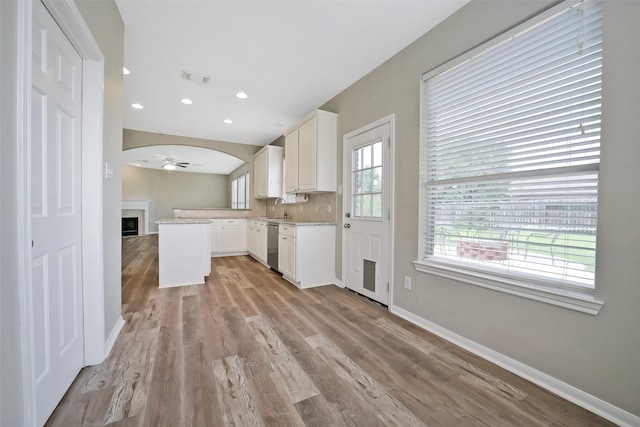 21326 Pebble Pine Trl, Cypress, TX 77433 - kitchen with stainless steel dishwasher, light countertops, a ceiling fan, light wood-style floors, and white cabinets