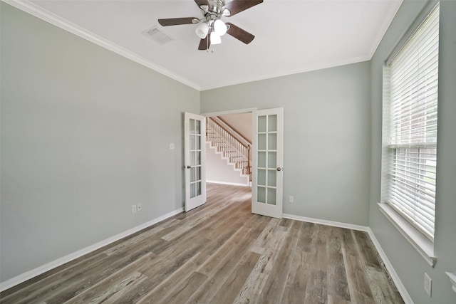 21326 Pebble Pine Trl, Cypress, TX 77433 - spare room featuring french doors, plenty of natural light, crown molding, wood finished floors, and ceiling fan