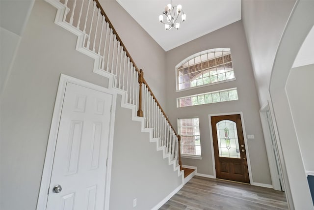 21326 Pebble Pine Trl, Cypress, TX 77433 - entrance foyer featuring a chandelier, stairs, wood finished floors, and a high ceiling