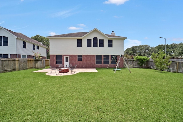 21326 Pebble Pine Trl, Cypress, TX 77433 - rear view of house with a patio, brick siding, a chimney, a fenced backyard, and an outdoor fire pit