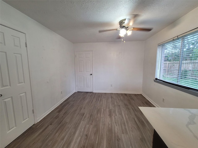 13930 New Village Ln, Sugar Land, TX 77498 - unfurnished room featuring dark wood-type flooring, ceiling fan, and a textured ceiling