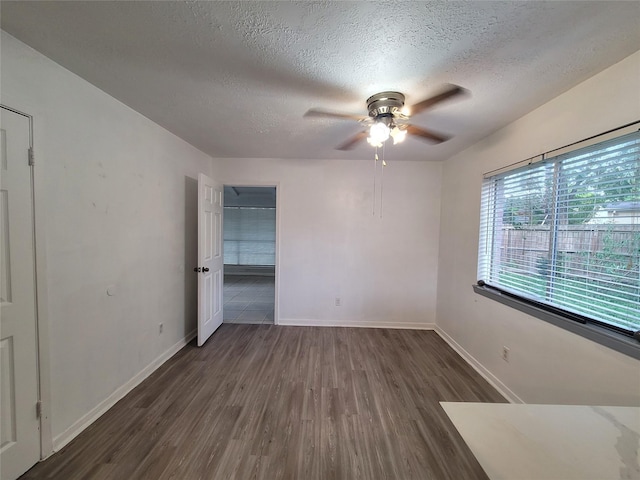 13930 New Village Ln, Sugar Land, TX 77498 - empty room featuring a ceiling fan, wood finished floors, and a textured ceiling