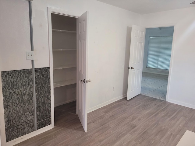 13930 New Village Ln, Sugar Land, TX 77498 - unfurnished bedroom with wood finished floors and a closet