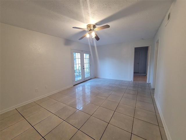 13930 New Village Ln, Sugar Land, TX 77498 - spare room featuring french doors, light tile patterned flooring, ceiling fan, and a textured ceiling