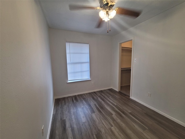 13930 New Village Ln, Sugar Land, TX 77498 - unfurnished bedroom featuring dark wood finished floors, a spacious closet, a closet, and ceiling fan