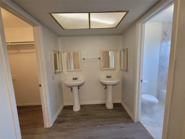13930 New Village Ln, Sugar Land, TX 77498 - full bathroom with toilet and wood finished floors